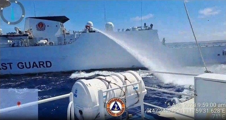 A China Coast Guard vessel fires a water cannon at the Philippine Coast Guard ship BRP Malabrigo in the South China Sea