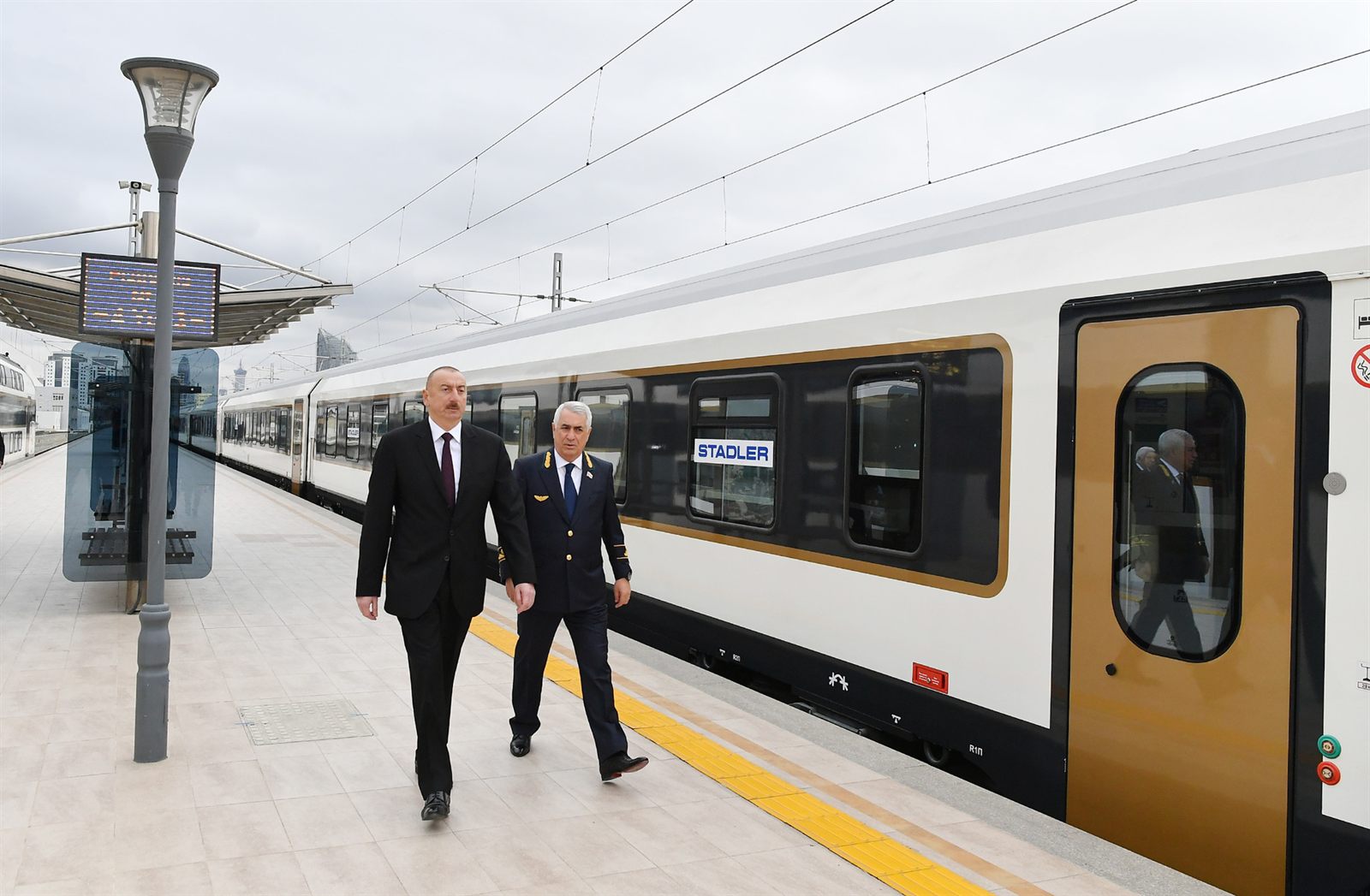 Azerbaijani President Ilham Aliyev views a passenger train on the Baku-Tbilisi-Kars railway line