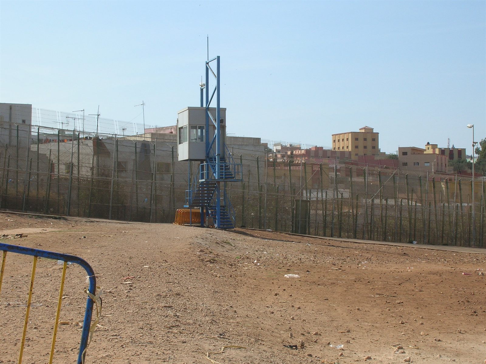 Acad Ronin / Wikimedia Commons · CC BY-SA 3.0 The high double border fence and a guard post at Melilla, the EU’s land frontier with Morocco