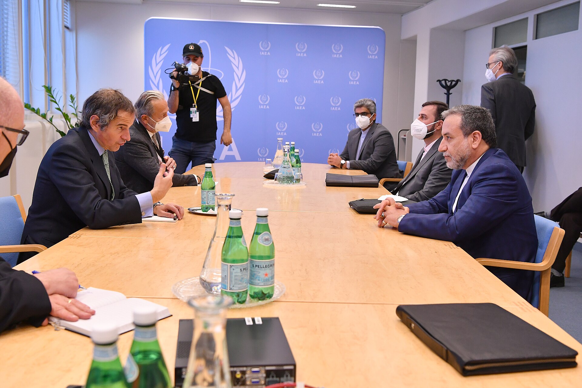 Iranian diplomat Abbas Araghchi, right, at a meeting table in Vienna