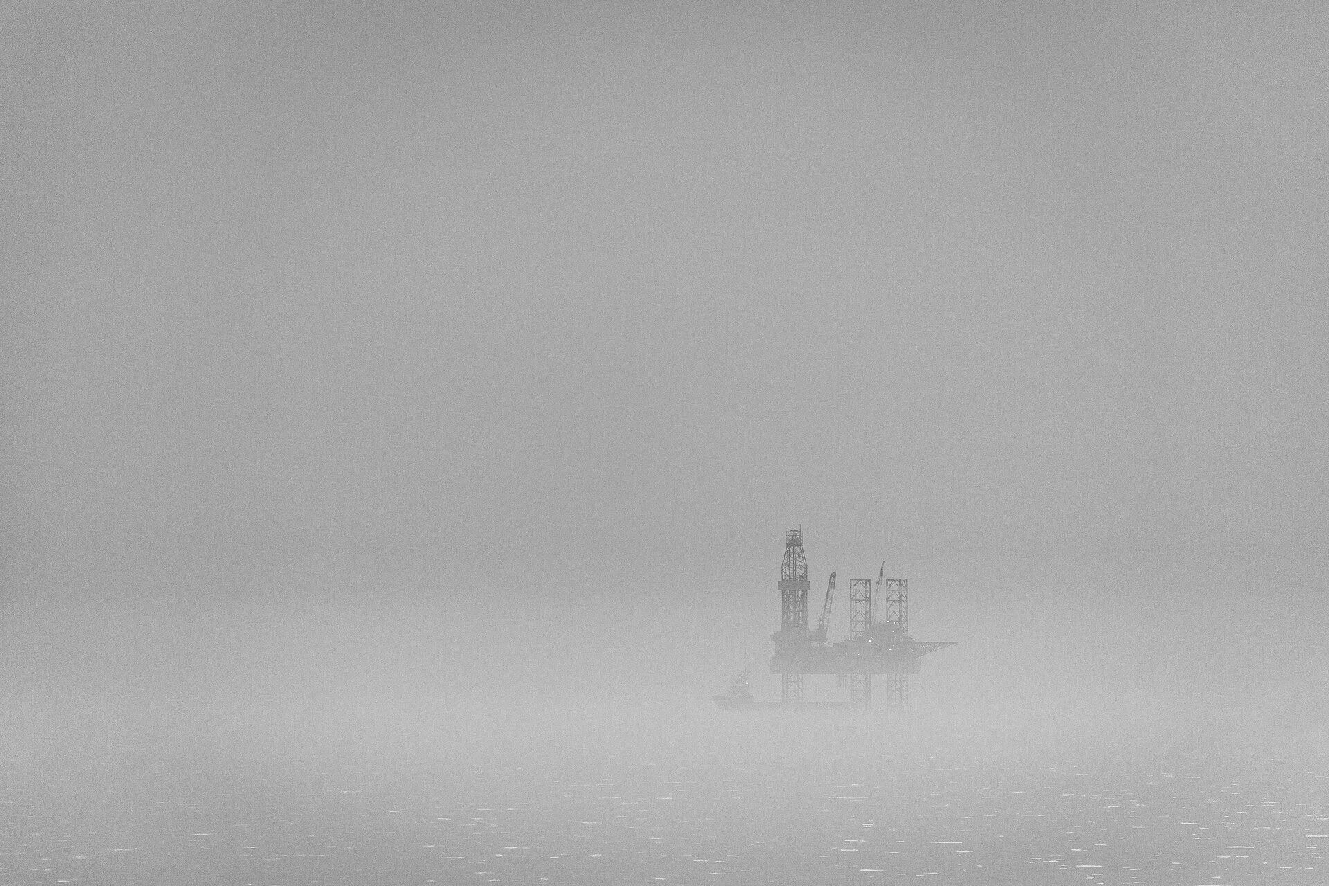 An operating oil rig in the North Sea seen through fog