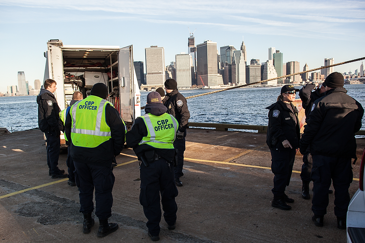US Customs and Border Protection officers inspecting stacked shipping containers at the Port of New York and New Jersey