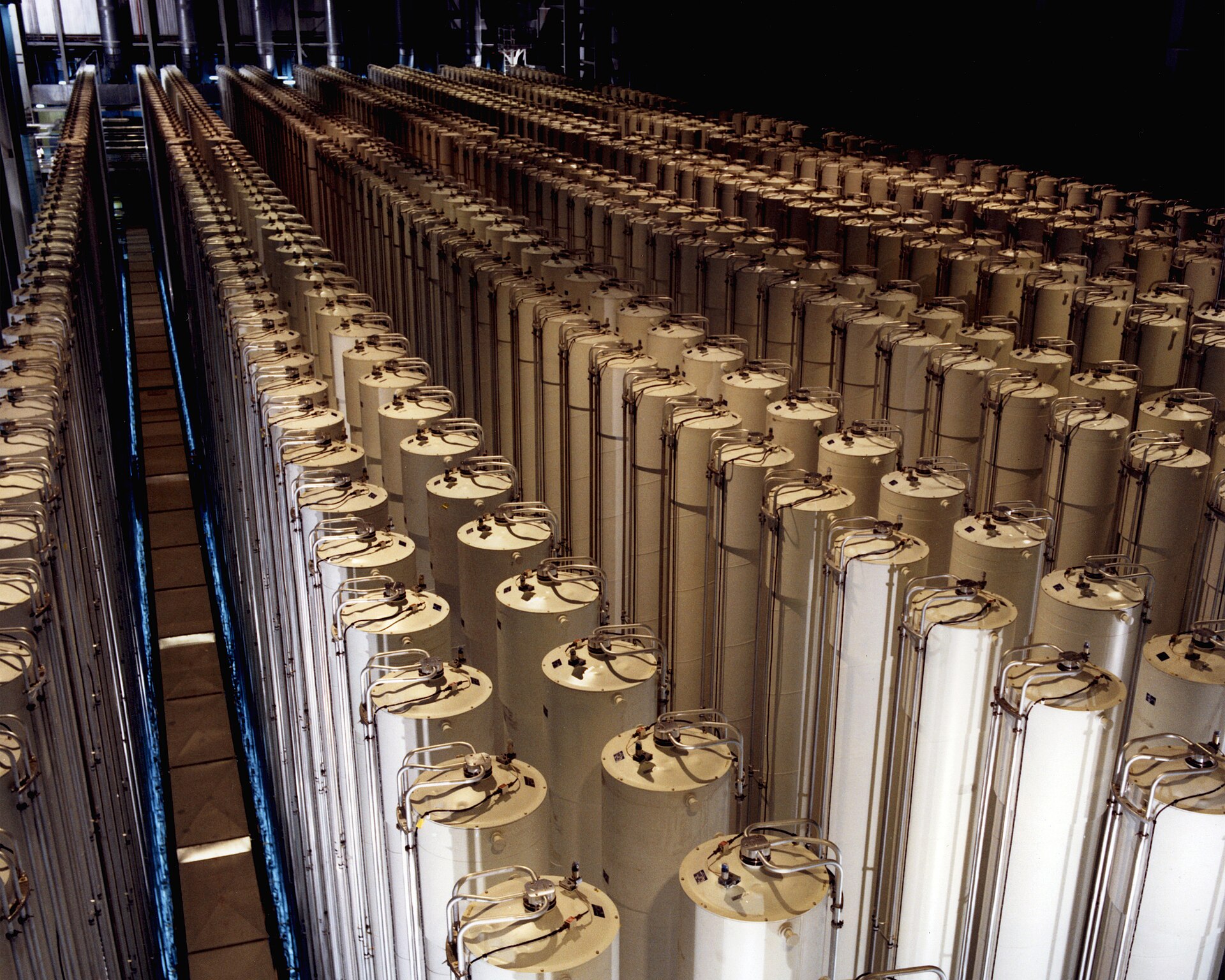 Rows of tall gas centrifuges arranged in a cascade for enriching uranium